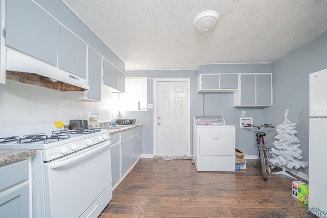 kitchen featuring white appliances, dark hardwood / wood-style floors, a textured ceiling, range hood, and washer / dryer