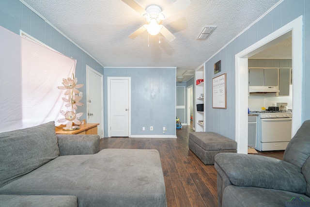 living room featuring ceiling fan, dark hardwood / wood-style flooring, and a textured ceiling