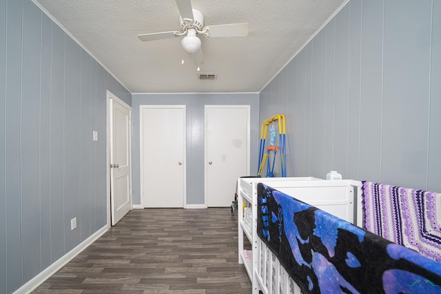 bedroom featuring a textured ceiling, ceiling fan, crown molding, and dark hardwood / wood-style floors