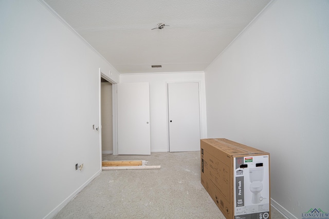 corridor featuring a textured ceiling