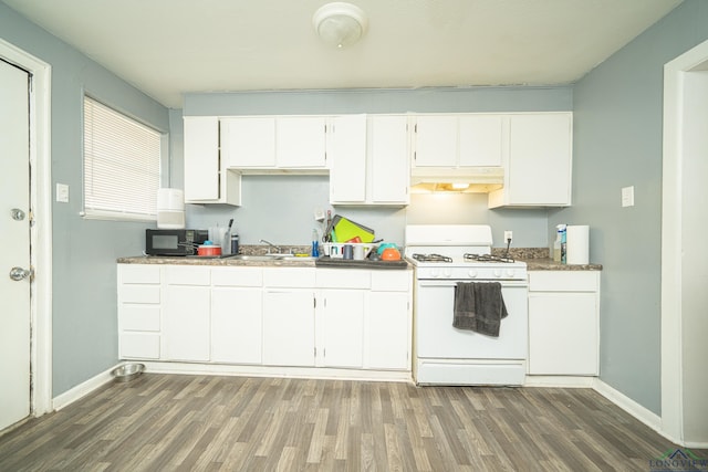 kitchen featuring dark hardwood / wood-style flooring, white cabinetry, white gas stove, and sink