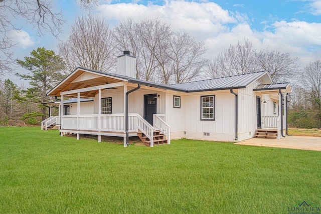 view of front of home with metal roof, crawl space, a chimney, and a front yard