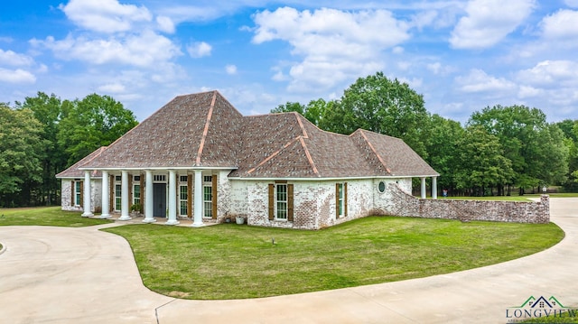 1882 County Road 3000, Joaquin, TX 75954 - view of front facade featuring a front lawn, concrete driveway, and covered porch