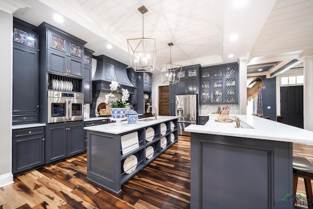 1882 County Road 3000, Joaquin, TX 75954 - kitchen with open shelves, appliances with stainless steel finishes, a center island with sink, dark wood finished floors, and ornamental molding