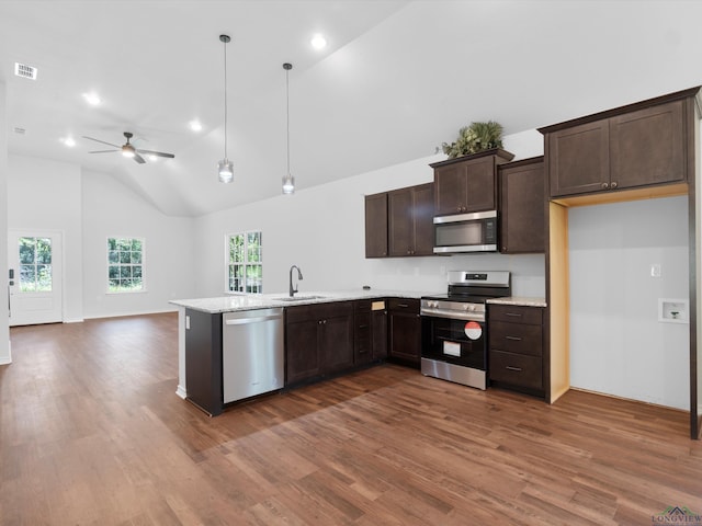 kitchen featuring pendant lighting, sink, ceiling fan, appliances with stainless steel finishes, and dark hardwood / wood-style flooring