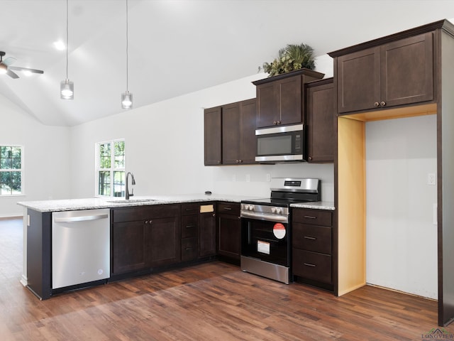 kitchen featuring dark brown cabinets, stainless steel appliances, dark wood-type flooring, sink, and decorative light fixtures