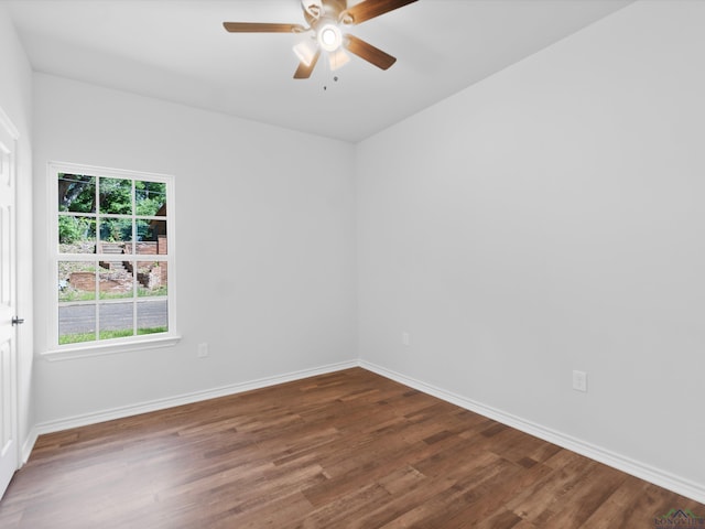 empty room featuring ceiling fan and dark hardwood / wood-style floors