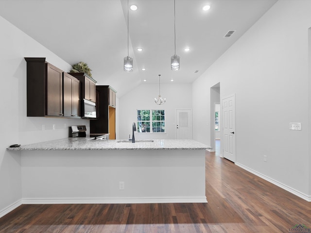 kitchen with stainless steel range with electric cooktop, sink, hanging light fixtures, dark brown cabinets, and kitchen peninsula