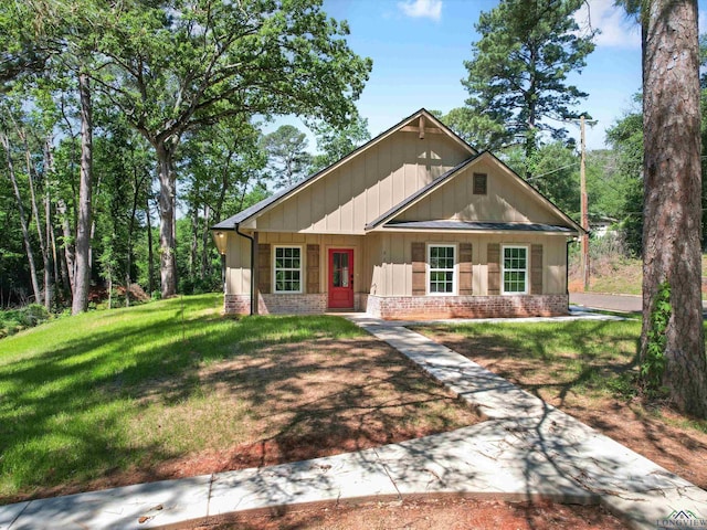 view of front of home with a porch and a front yard