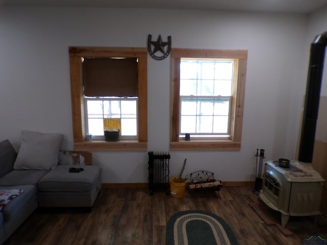 sitting room featuring radiator, wood finished floors, and baseboards