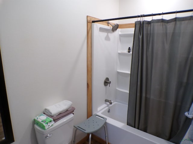 bathroom featuring shower / bath combo with shower curtain and toilet