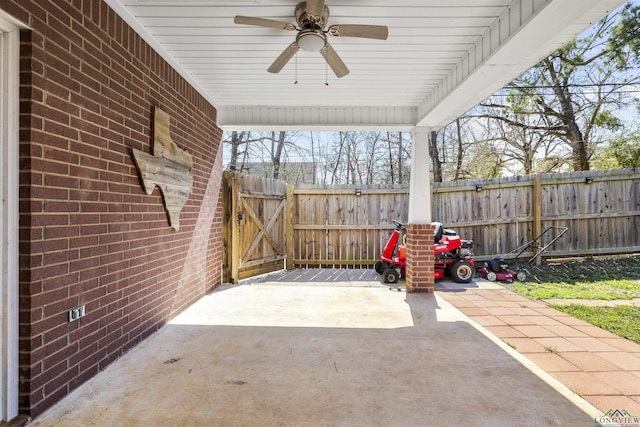 view of patio / terrace with a gate, a ceiling fan, and fence