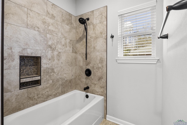 bathroom with tub / shower combination and baseboards