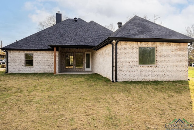 back of house featuring a yard and a patio area