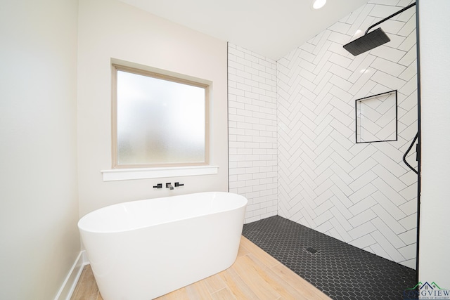 bathroom featuring hardwood / wood-style flooring and independent shower and bath