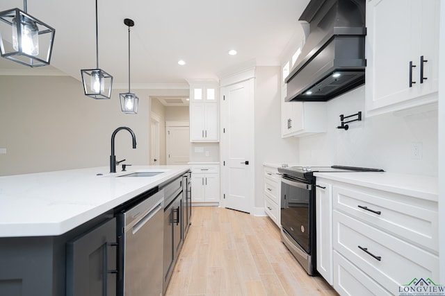 kitchen featuring custom exhaust hood, a center island with sink, sink, hanging light fixtures, and stainless steel appliances