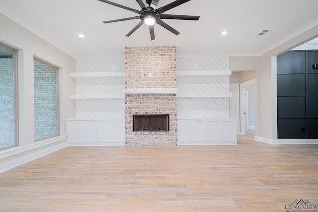 unfurnished living room with a fireplace, light hardwood / wood-style flooring, ceiling fan, and ornamental molding