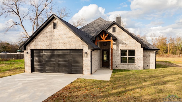 view of front of property with a garage and a front lawn