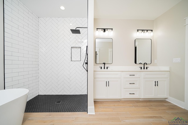 bathroom with vanity and separate shower and tub