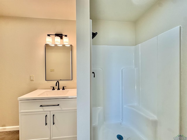 full bath featuring walk in shower and vanity