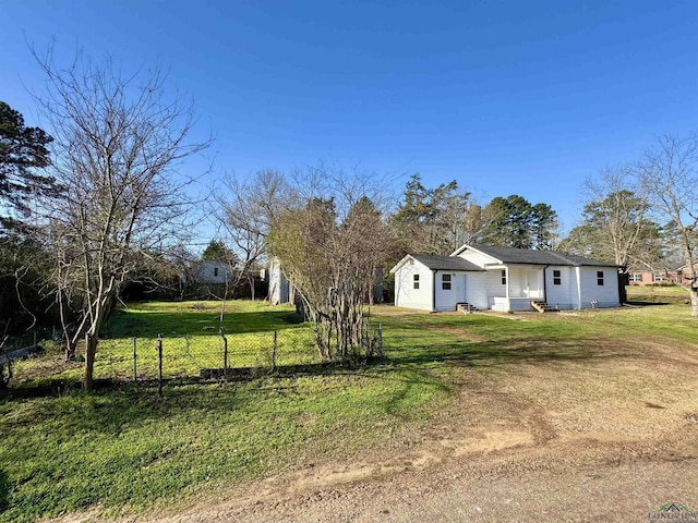 exterior space featuring a front yard and fence