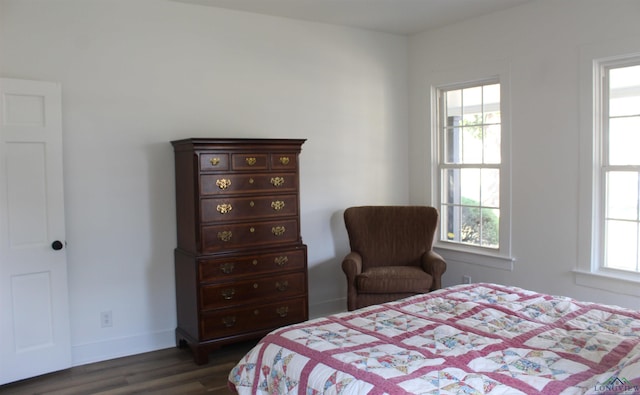 bedroom with dark wood-type flooring