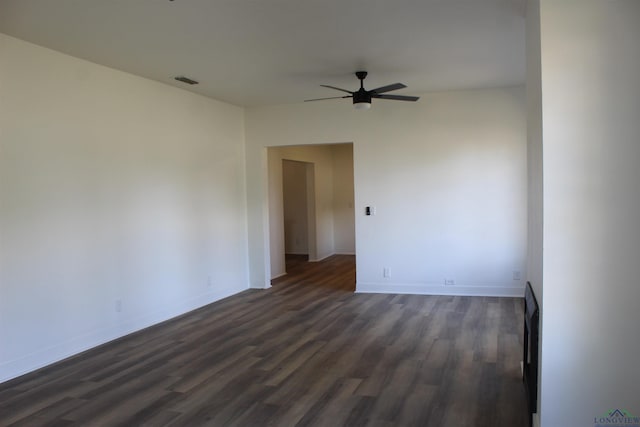 empty room with ceiling fan and dark hardwood / wood-style flooring