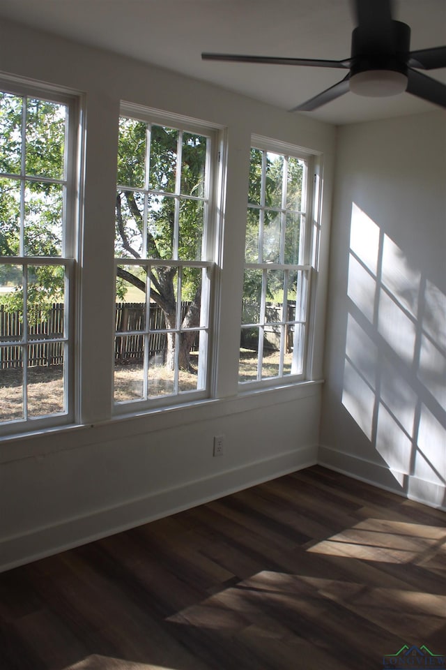 unfurnished sunroom with ceiling fan and a wealth of natural light