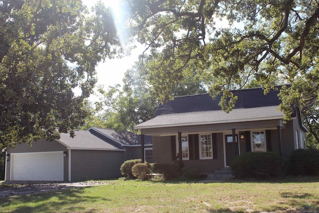 view of front of house featuring a garage and a front lawn