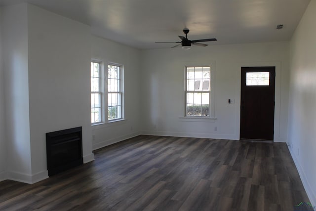 unfurnished living room with ceiling fan and dark hardwood / wood-style floors