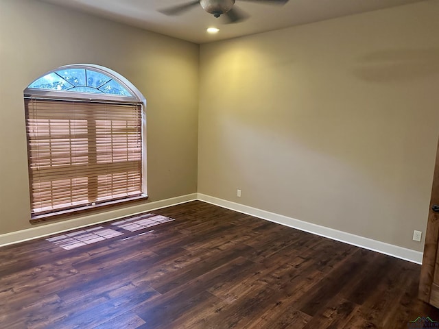 empty room featuring ceiling fan and dark hardwood / wood-style floors