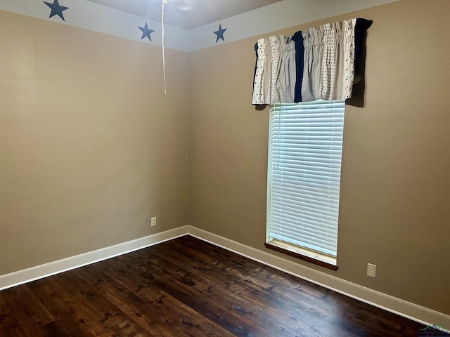 spare room featuring dark wood-type flooring