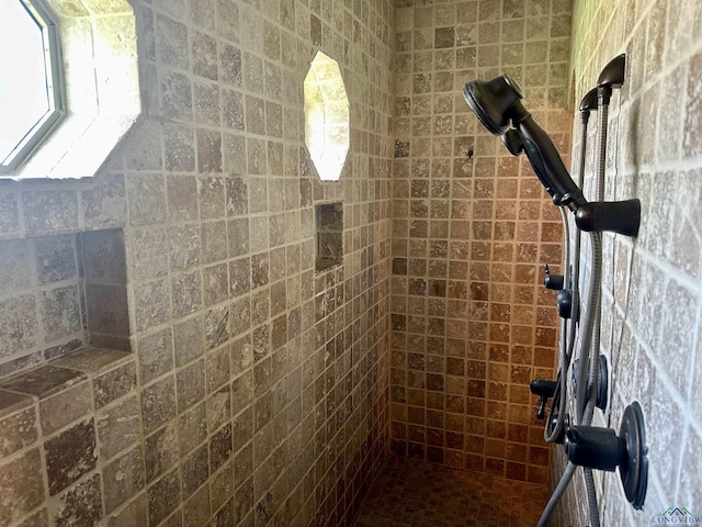 bathroom with tiled shower