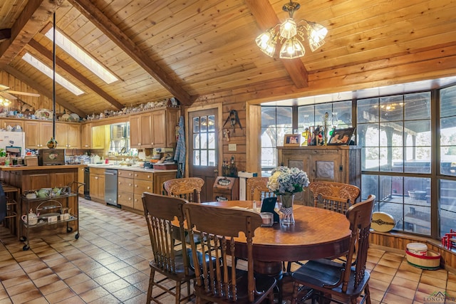 tiled dining area featuring a healthy amount of sunlight, beam ceiling, high vaulted ceiling, and a skylight