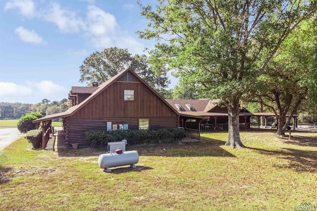 view of side of home with a lawn