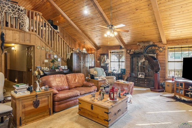 carpeted living room with beamed ceiling, a wealth of natural light, wooden walls, and wood ceiling