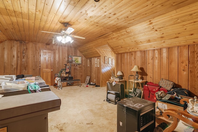 carpeted bedroom with wooden walls, ceiling fan, wood ceiling, and lofted ceiling