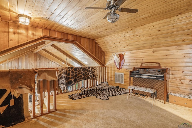 interior space with vaulted ceiling, carpet floors, wooden walls, and wooden ceiling