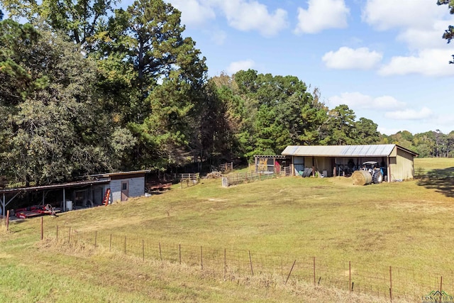 view of yard featuring an outbuilding and a rural view