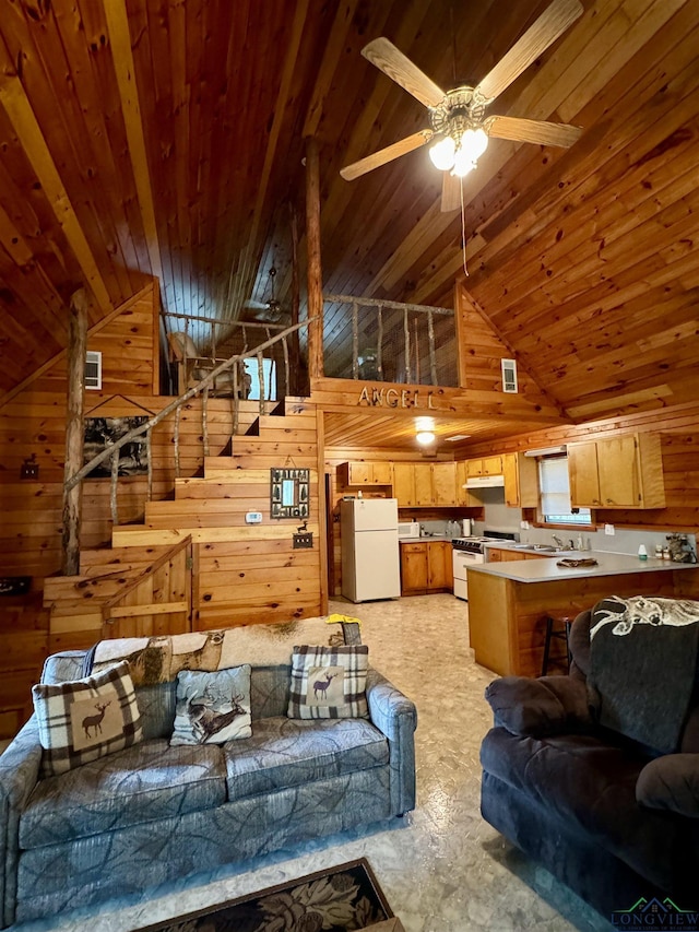 living room with wood walls, wood ceiling, and high vaulted ceiling