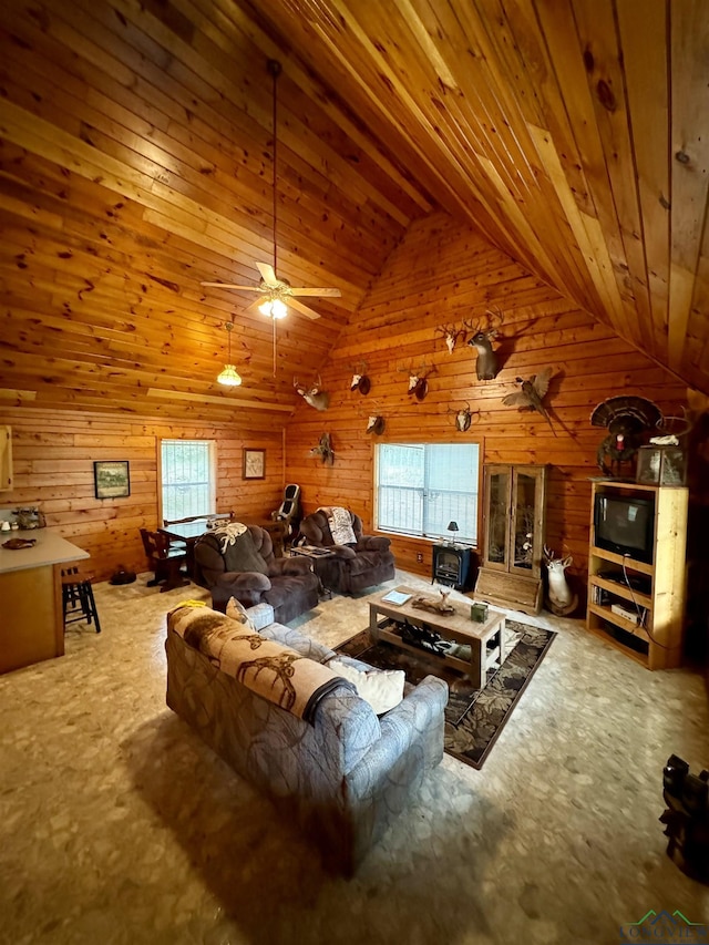 carpeted living room with ceiling fan, plenty of natural light, wooden ceiling, and lofted ceiling