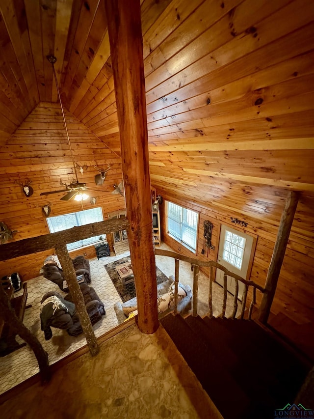 bonus room with ceiling fan, wood walls, wooden ceiling, and vaulted ceiling