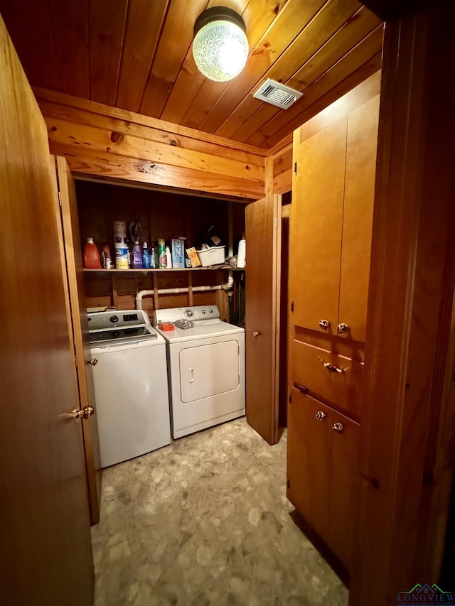 clothes washing area featuring independent washer and dryer and wood ceiling