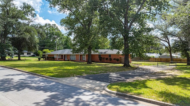 ranch-style home with a front yard