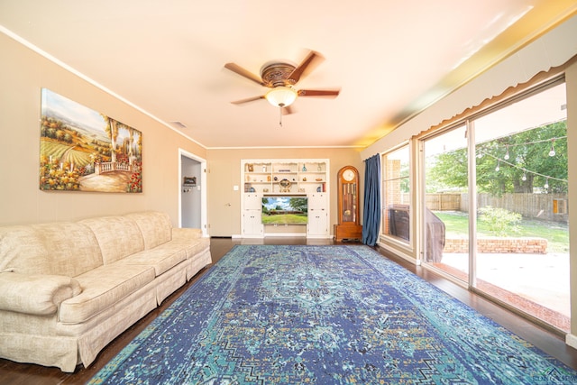 living room with hardwood / wood-style floors, ceiling fan, built in features, and ornamental molding