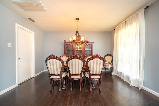 dining room with a chandelier and dark hardwood / wood-style flooring