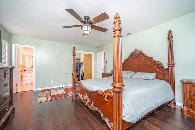 bedroom featuring ensuite bath, a spacious closet, ceiling fan, dark wood-type flooring, and a closet