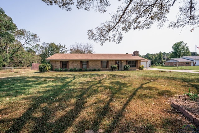 ranch-style home with a garage and a front lawn