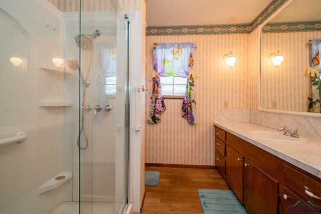 bathroom featuring hardwood / wood-style floors, vanity, and an enclosed shower