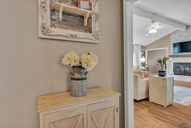 details with ceiling fan, a fireplace, beam ceiling, and wood finished floors